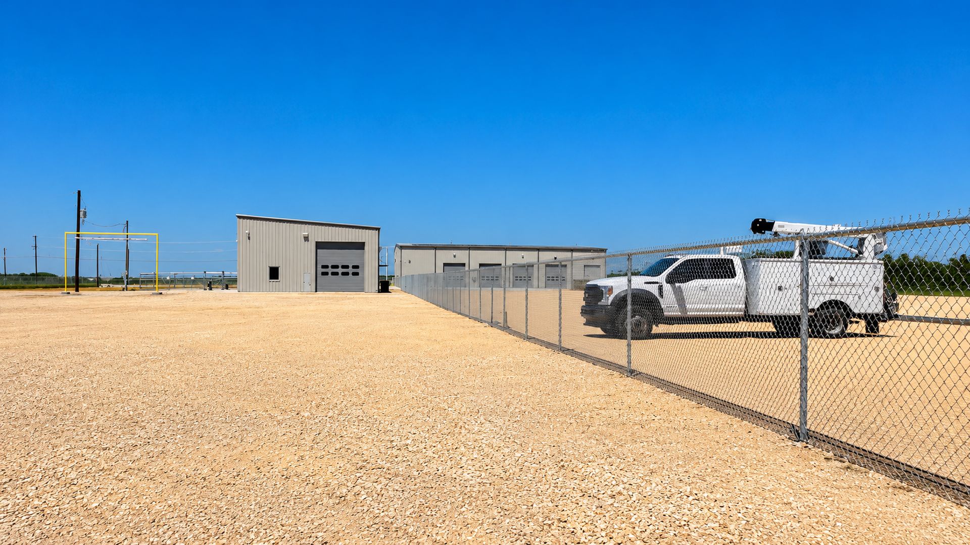 Galvanized chain link security fence DLG Fence installed around a commercial yard in Central Texas